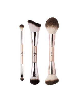 Set of makeup brushes with rose gold handles on a white background
