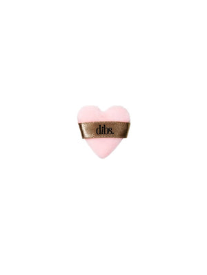 Heart-shaped pink powder puff with a brown ribbon on a white background