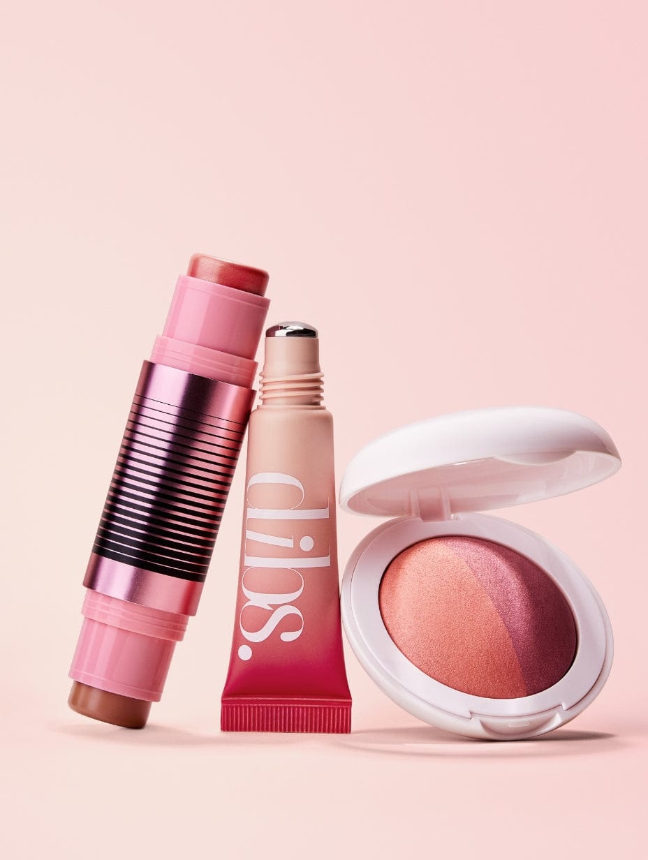 Makeup products including a liquid blush tube, blush + contour duo, and baked blush on a pink background