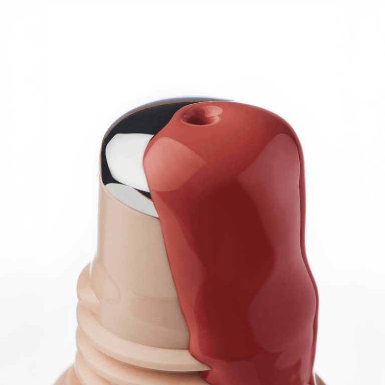 Close-up of a reddish liquid blush on a white background