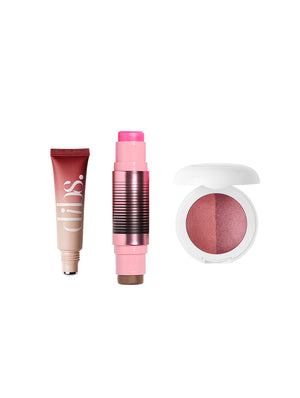 Three makeup products including a tube, stick, and compact on a white background