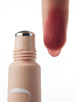 Cool Blush roller applicator with a swatch of dark pink color on a finger against a white background